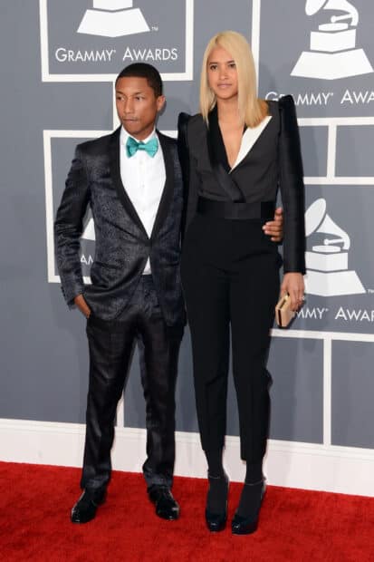 Pharrell Williams standing with a woman on the Grammy Awards red carpet, HD Desktop Wallpaper