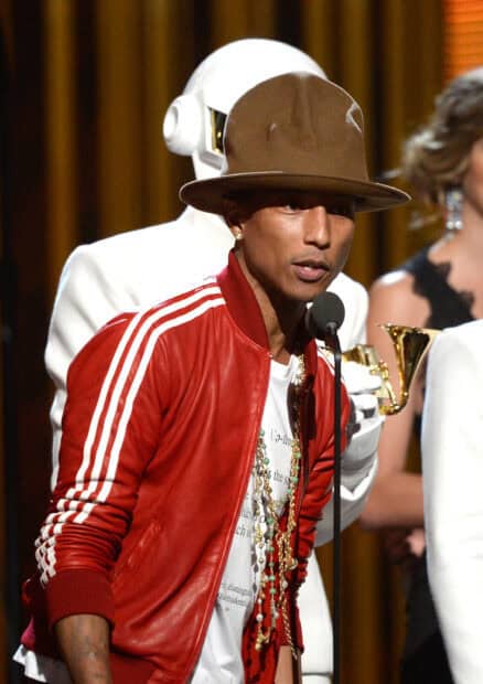 Pharrell Williams speaking at the microphone wearing a red jacket and brown hat, 2K Mobile Wallpaper