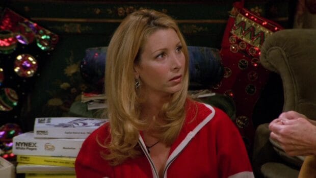 Phoebe Buffay watches intently during a conversation in a cozy room, HD Desktop Wallpaper