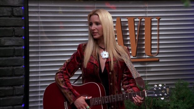 Phoebe Buffay wallpapers show her performing with guitar indoors, HD Desktop Wallpaper