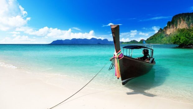 A traditional boat rests on the turquoise water near the sandy beach in Phuket wallpapers HD and 4K, HD Desktop Wallpaper
