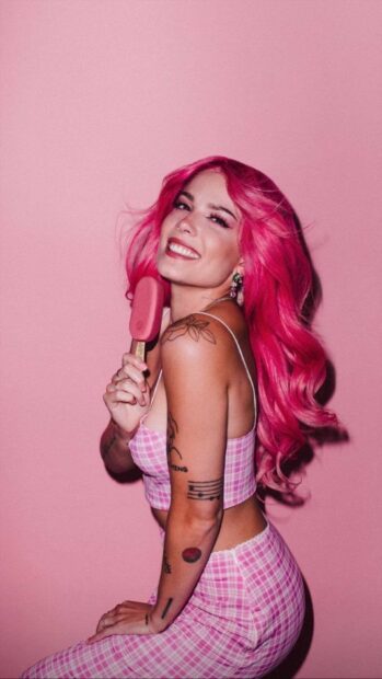 A smiling woman with pink hair and tattoos poses holding a popsicle featuring Halsey Wallpapers