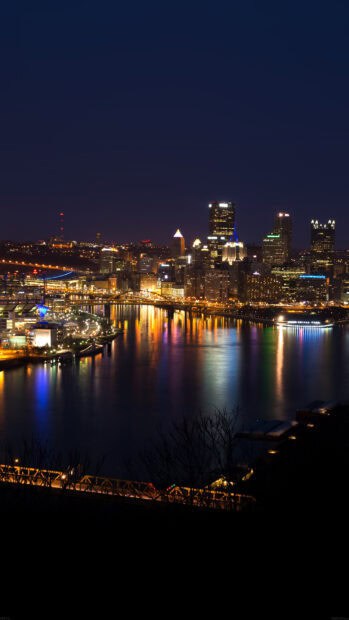 The Pittsburgh skyline shows illuminated buildings reflecting on the river at night, HD Mobile Wallpaper