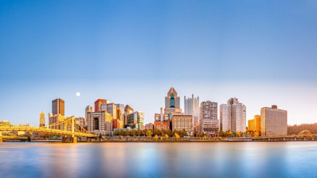 The Pittsburgh skyline features buildings and bridges under a clear sky at sunset, 4K Desktop Wallpaper