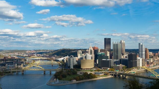 The Pittsburgh skyline features multiple bridges and tall buildings under a partly cloudy sky, HD Desktop Wallpaper