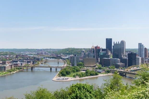 A view of Pittsburgh skyline featuring multiple bridges over the river and city buildings in the background, 2K Desktop Wallpaper