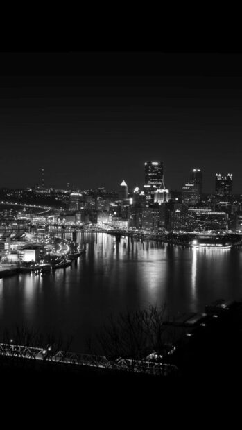 The Pittsburgh skyline at night reflects on the calm river with city lights glowing, HD Phone Wallpaper