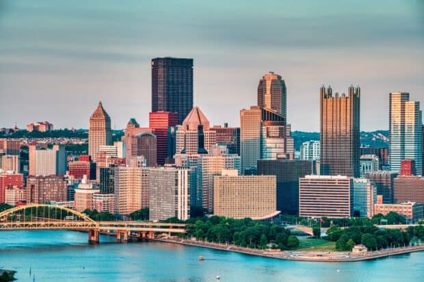 The Pittsburgh skyline features prominent buildings under a calm evening sky, HD Desktop Wallpaper