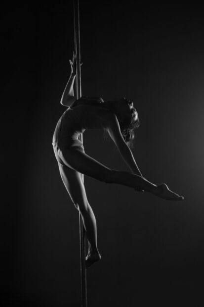 A woman performing an elegant pole dance artistic pose in black and white, HD Mobile Wallpaper