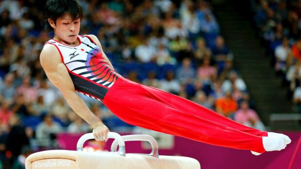 A gymnast performs a pommel horse routine at a competition, HD Desktop Wallpaper