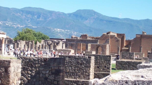 A vibrant view of Pompeii ruins with tourists and mountains in the background captures the historical site well, HD Desktop Wallpaper