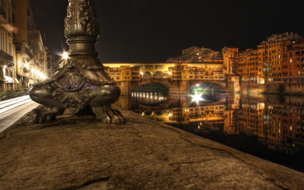 The Ponte Vecchio at night reflects beautifully in the calm river water with city lights, HD Desktop Wallpaper