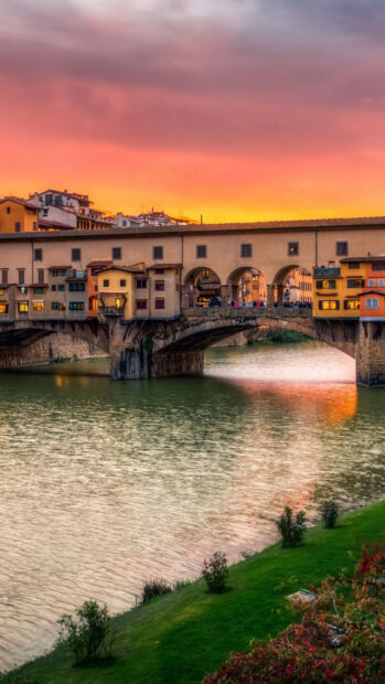 The Ponte Vecchio shows colorful buildings over the river at sunset with a vibrant sky, HD Mobile Wallpaper