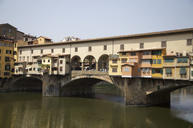 The Ponte Vecchio bridge crosses the Arno River with colorful buildings in Florence, Italy, HD Desktop Wallpaper