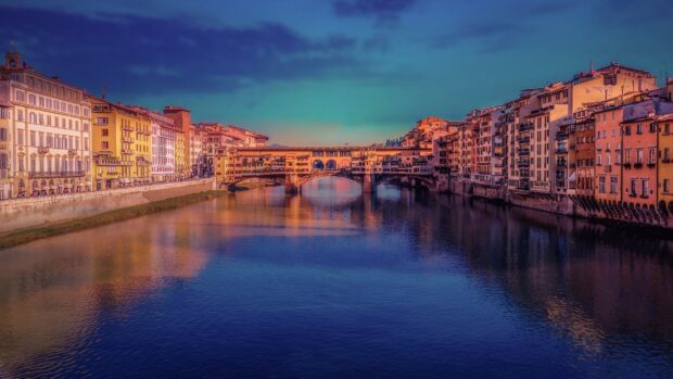 The Ponte Vecchio shows colorful buildings reflected in the calm river under a twilight sky, HD Desktop Wallpaper