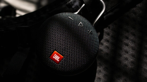 A close up of a portable Bluetooth speaker with JBL wallpapers in a dark setting, HD Desktop Wallpaper