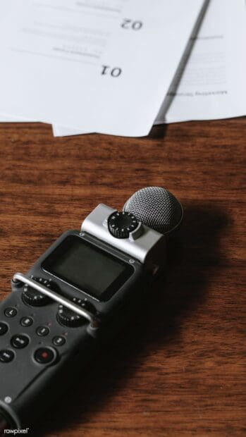 A portable audio recorder with microphone and control buttons placed on a wooden surface, HD Mobile Wallpaper