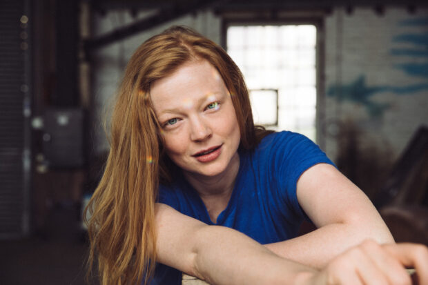 A close up portrait of Sarah Snook wearing a blue shirt in an indoor setting, 2K Desktop Wallpaper