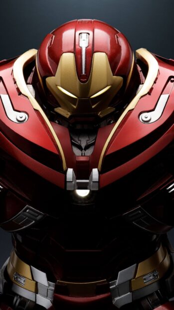 The Hulkbuster armor stands strong with detailed red and gold plating, 4K Phone Wallpaper
