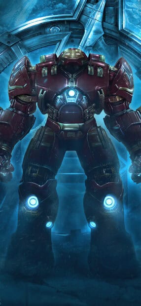 The image shows a powerful Hulkbuster suit standing in a futuristic environment with mechanical and glowing blue elements, HD Phone Wallpaper