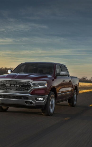 A red Ram pickup is driving down a rural highway at sunset, HD Phone Wallpaper