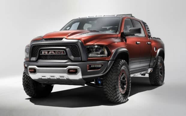 A red Ram Pickup truck with large off road tires and rugged features is shown in a studio, HD Desktop Wallpaper