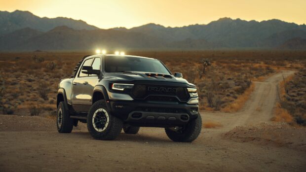 A Ram truck is parked on a dirt road with mountains in the background during sunset, 4K Desktop Wallpaper