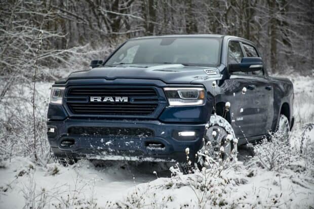 A powerful Ram truck is parked on a snow covered ground with frosty trees in the background, HD Desktop Wallpaper