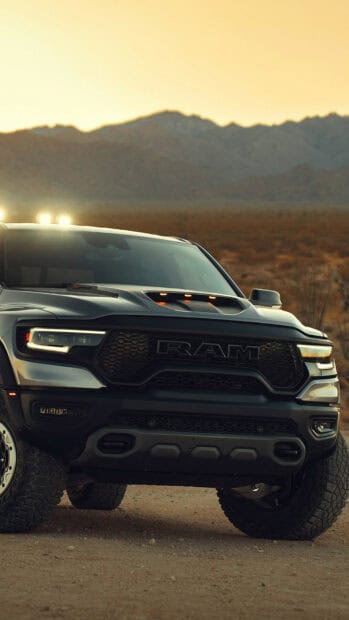 A powerful Ram truck with lights on is parked on a dirt road at sunset, HD Mobile Wallpaper