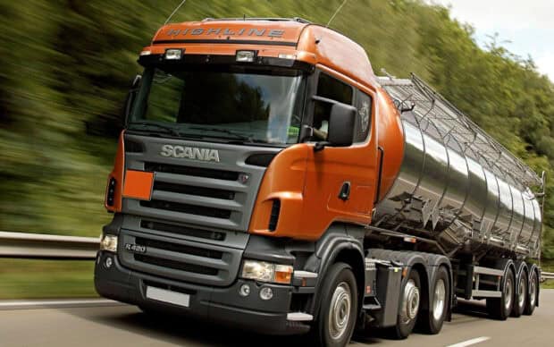 A powerful orange Scania truck is driving fast on the highway with a trailer attached, HD Desktop Wallpaper