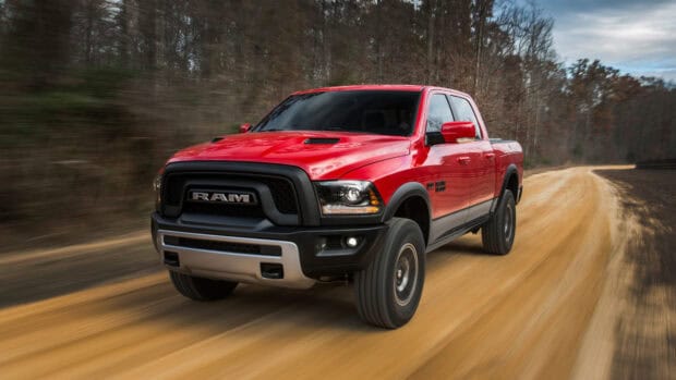A red Ram truck is driving fast on a dusty countryside road, 4K Desktop Wallpaper