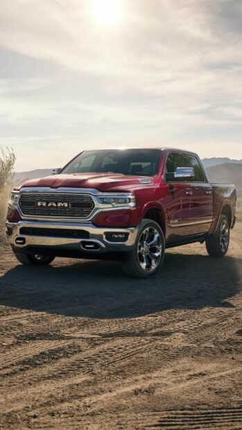 A red Ram truck is parked on a dirt road with mountains and a cloudy sky in the background, HD Phone Wallpaper