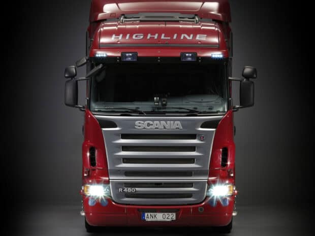 A powerful red Scania truck with bright headlights and a Highline logo is displayed, HD Desktop Wallpaper
