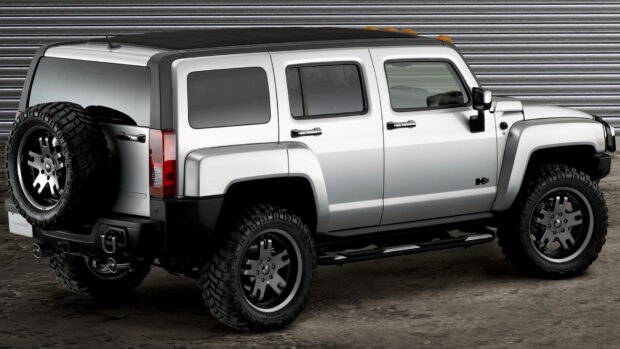 A silver Hummer H3 with off road tires is parked indoors, HD Desktop Wallpaper