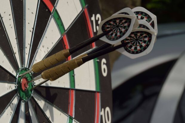 Two darts stick firmly in the bullseye of the dartboard demonstrating skill in the game, 2K Desktop Wallpaper