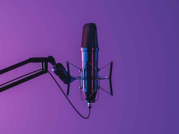 A professional microphone is shown with purple lighting on a solid background, HD Desktop Wallpaper