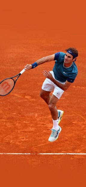 A professional tennis player is mid air hitting a forehand on a clay court using a racket, HD Phone Wallpaper