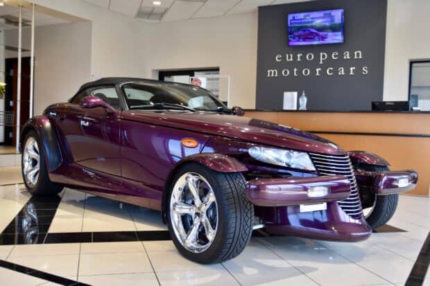 A purple Plymouth Prowler is displayed inside a car dealership showroom by European Motorcars, HD Desktop Wallpaper