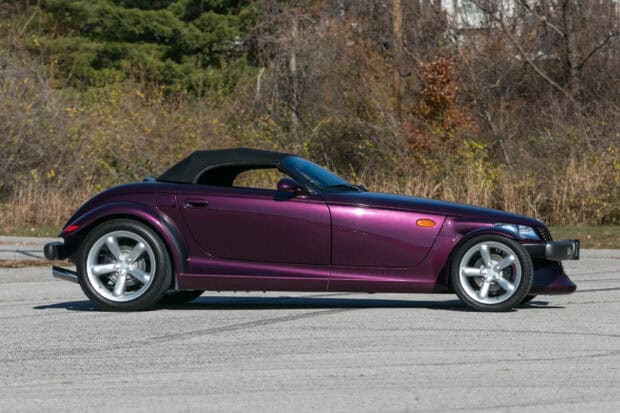 A purple Plymouth Prowler is parked on an empty road near autumn trees, HD Desktop Wallpaper
