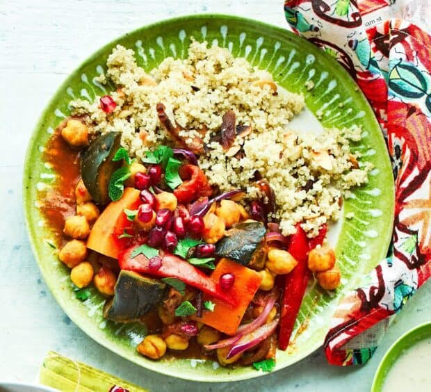 A colorful quinoa dish with chickpeas and vegetables garnished with pomegranate seeds, HD Desktop Wallpaper