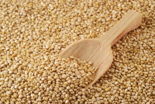 A wooden scoop resting on a pile of quinoa grains filling the frame, HD Desktop Wallpaper
