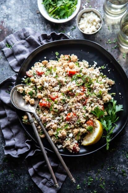 A healthy quinoa dish with tomatoes, herbs, and chickpeas on a dark plate, HD Mobile Wallpaper