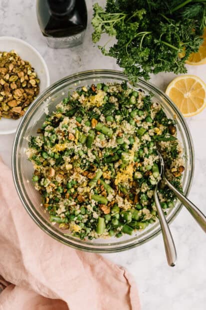 A bowl of quinoa with green peas, herbs, and nuts on a marble surface, HD Mobile Wallpaper