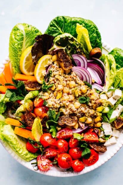 A colorful quinoa salad with fresh tomatoes, lettuce, and onions in a bowl, HD Mobile Wallpaper