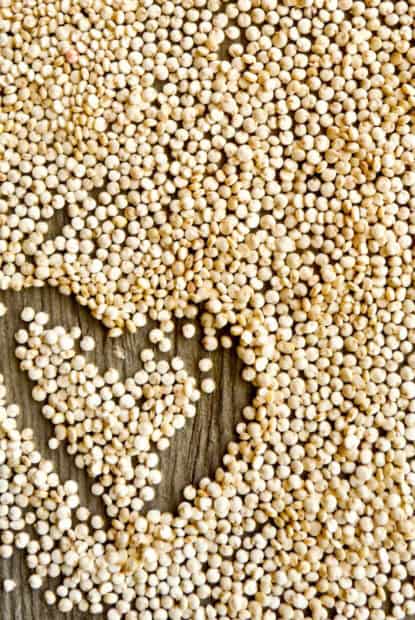 Quinoa wallpapers arranged in a heart shape on a wooden surface, 2K Mobile Wallpaper