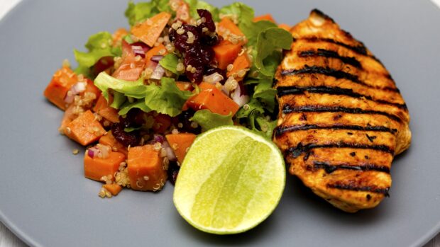 A plate of quinoa with diced vegetables, greens, and grilled chicken served with a lime slice, 4K Desktop Wallpaper