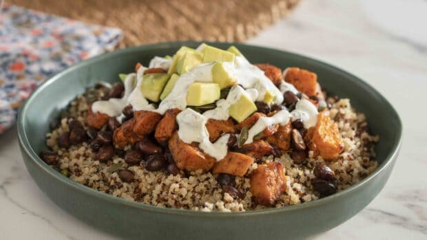 A bowl of quinoa with roasted sweet potatoes, black beans, avocado, and drizzle of sauce, HD Desktop Wallpaper