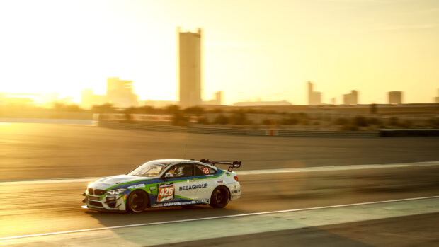 A race car is speeding along the race track during a sunset in the city, 4K Desktop Wallpaper