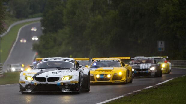 A group of race cars competing on a wet race track with headlights on, HD Desktop Wallpaper