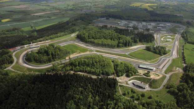 The race track circuit is surrounded by dense forests and green fields, HD Desktop Wallpaper